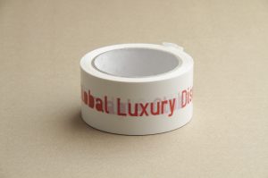 Tape: Caution Unconsumable Global Luxury Dispersion. Self Adhesive Vinyl Tape, 50mm x 60m. Printed red text with SymLogiDIN font. Walter van Rijn 2015-2018 [8.4.4.02]